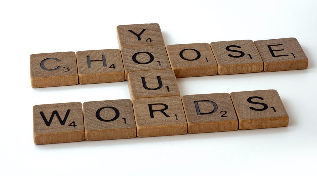 Scrabble tiles that spell out Choose Your Words.
